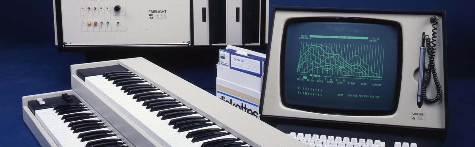 Two synthesiser keyboards, a 1980s-style computer monitor and keyboard, and a box of floppy discs belonging to the Fairlight CMI music sampler