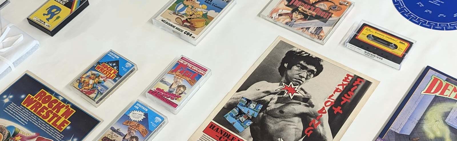 Retro video games laid out on a table. Titles include Rock'n Wrestle and Exploding Fist with Bruce Lee