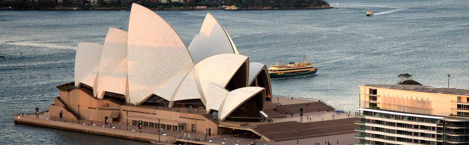 The Sydney Opera House seen from the air, with the harbour behind it