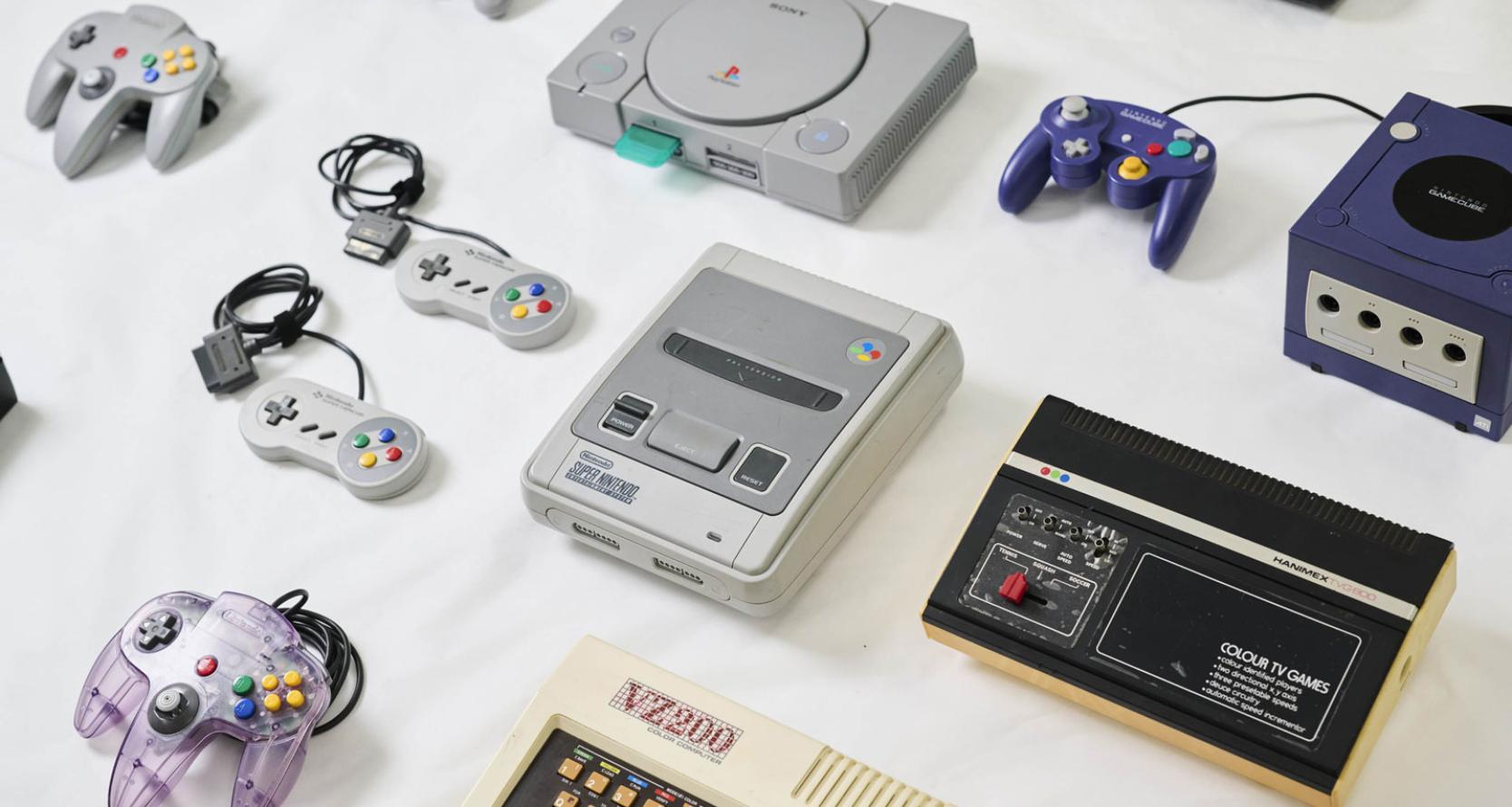 Video game consoles and hardware laid out on a table
