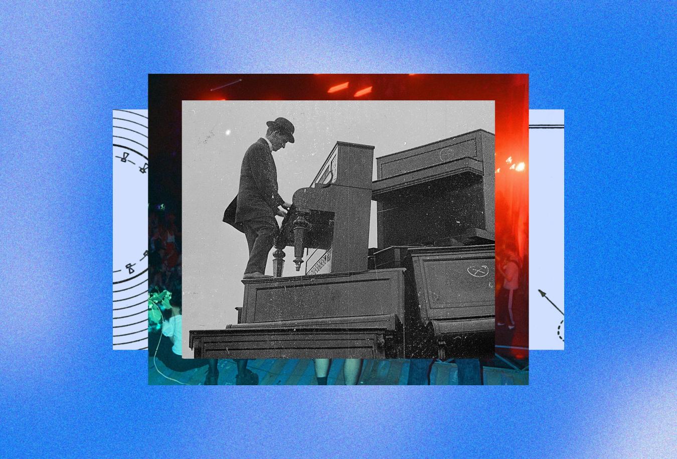 A man in a suit and bowler hat plays an upright piano while standing on another piano in a stack of junked pianos