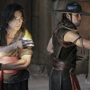 Two Asian men who are dressed like Samurai