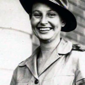 Head and shoulders image of a woman in an army uniform smiling