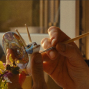 Woman painting porcelain sculpture