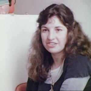 A woman sitting in the kitchen taking part in an interview for a late 1970s documentary