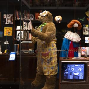 The costumes for children's TV characters Fredd the Bear and Bobo the Clown on display in a glass case at the NFSA.