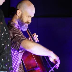 Christopher Pidcock plays the cello into a large gramophone horn, to record a wax cylinder.