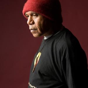 Indigenous singer/songwriter Archie Roach, pictured in profile from the waist up.