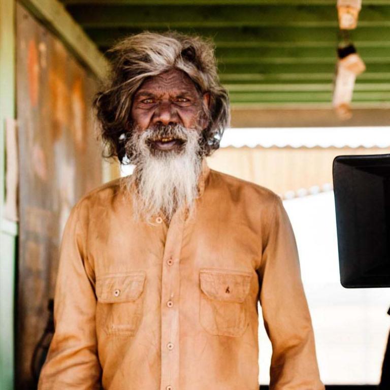 David Gulpilil pictured from the waist up, looking directly at the camera