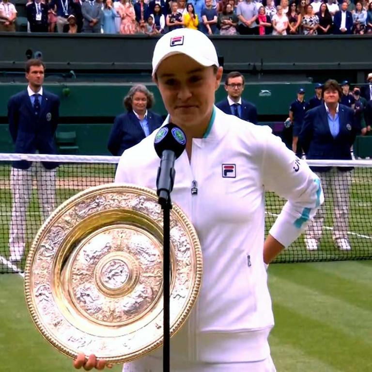 Tennis player Ash Barty holding the Wimbledon trophy, 2021