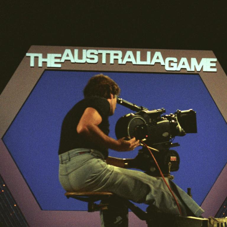 A behind-the-scenes shot of 1970s TV game show The Australia Game with a camera operator filming host Dal Myles on set