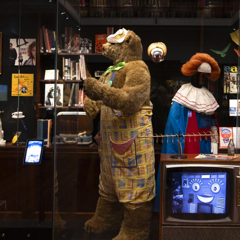 The costumes for children's TV characters Fredd the Bear and Bobo the Clown on display in a glass case at the NFSA.