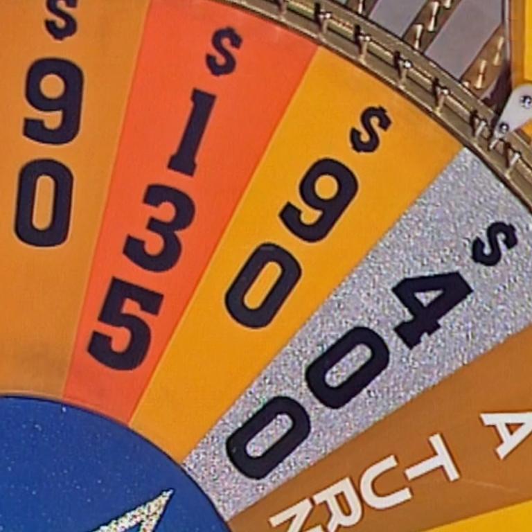 A section of a game show wheel with different dollar amounts written on each section and one section that says Lose A Turn.