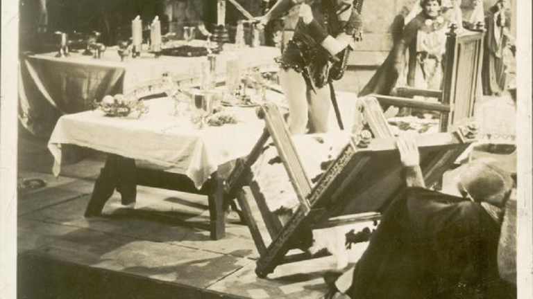 The Adventures of Robin Hood_Errol Flynn upturns a table Errol Flynn upturns a table in a baqueting hall.