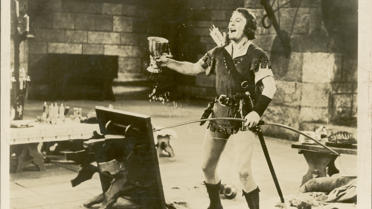 The Adventures of Robin Hood_Errol Flynn with wine goblet Errol Flynn brandishes an oversized wine goblet