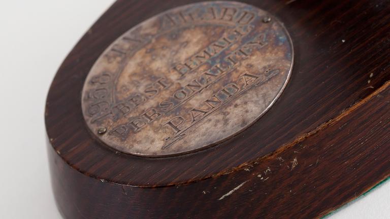 A close up of the base of a TV Week Award, The inscription on it reads '1958 TV Award. Best TV Personality. Panda'.