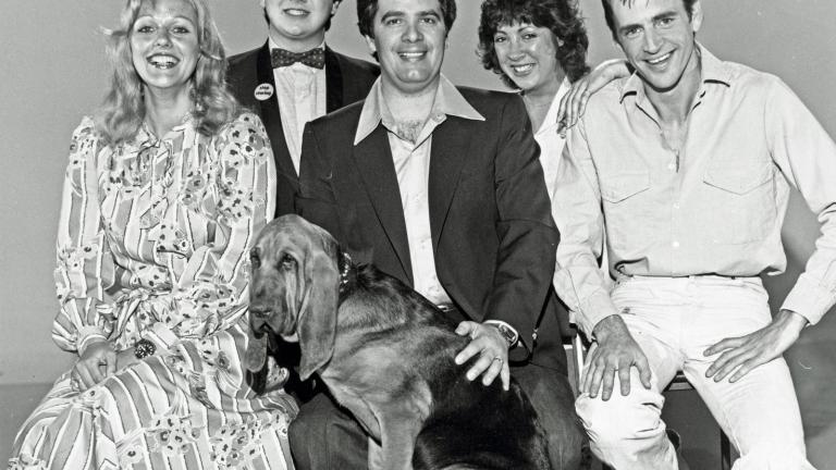 Publicity still for Simon Townsend's Wonder World! featuring the reporters and host. Pictured from left to right: Sandra Mauger, Jonathan Coleman, Simon Townsend, Angela Catterns, Adam Bowen, seated in front: Woodrow the bloodhound.