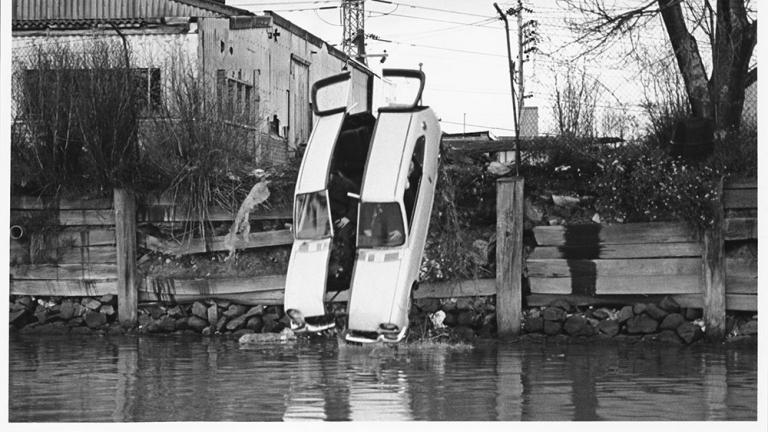 The two halves of Malcolm's getaway car plunge into a river