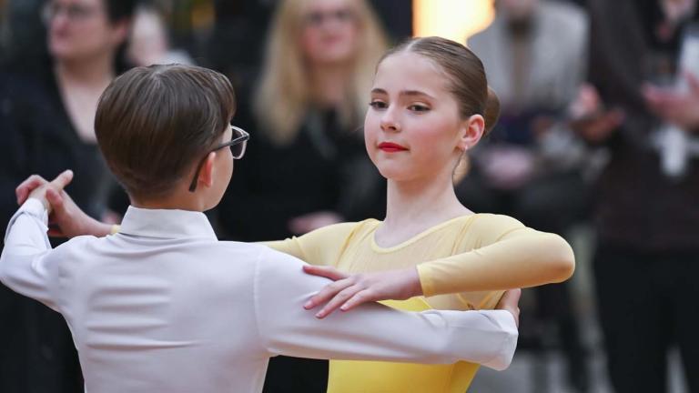 Two children ballroom dancing in the NFSA courtyard