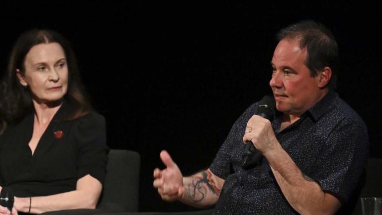 Paul Mercurio on stage at the NFSA discussing Strictly Ballroom during a Q&A session while Tara Morice watches