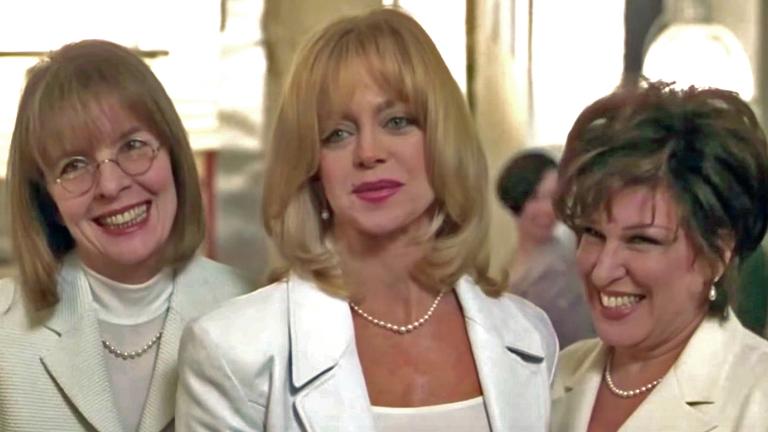 Head and shoulders shot of three women wearing white blazers (Diane Keaton, Goldie Hawn and Bette Midler) smiling in a scene from the film The First Wives Club.
