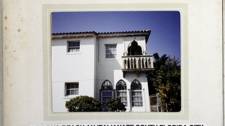 Page from a scrapbook with a photo of an Italianate house.