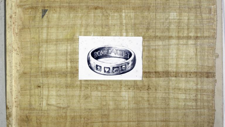 Front of a scrapbook with a picture of a wedding band on it.