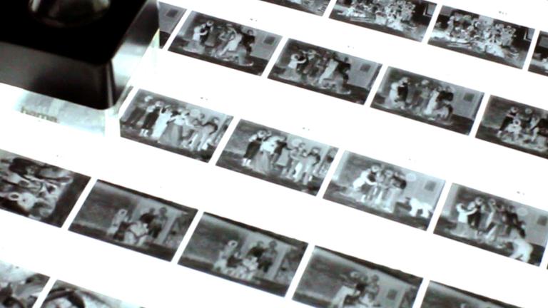 Close up of a lightbox with strips of film placed on it.