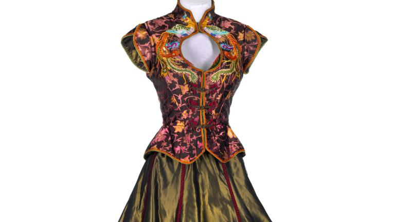 Costume on a mannequin featuring a bodice with an ornate asian-influenced design and a full skirt. The costume was worn by a dancer in the film Moulin Rouge!
