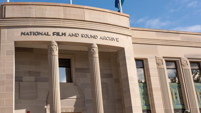 Front facade of an art deco style building with columns at the front and a sign saying National Film and Sound Archive.