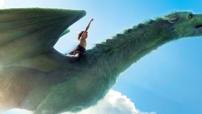 A young boy riding on the back of a flying dragon with one arm raised toward the sky