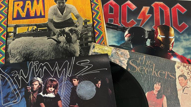 Four record covers laid out on a table.
