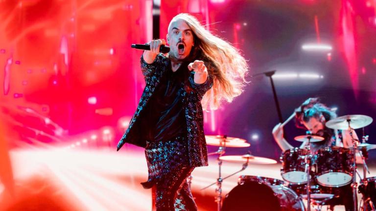 Daniel Estrin, lead singer of the rock band Voyager, points at the camera while rehearsing on the Eurovision Song Contest stage with drummer Ashley Doodkorte