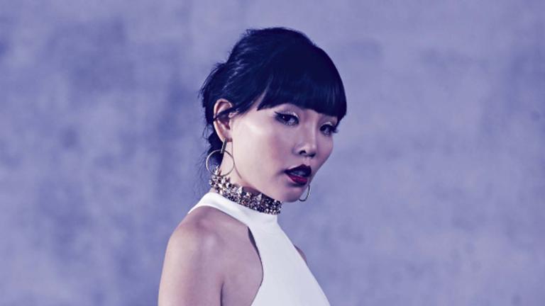 Singer Dami Im wearing a white dress in the Eurovision Song Contest photo studio