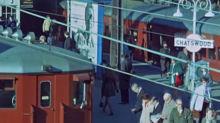 A train station in the Sydney suburb of Chatswood showing 'red rattler' commuter trains from circa 1970s and people waiting on the platforms.