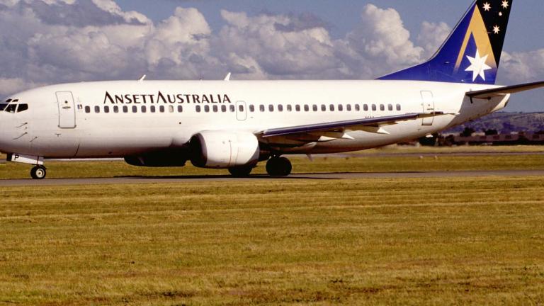 Ansett Australia Boeing 737-300 airplane on a runway on a sunny day