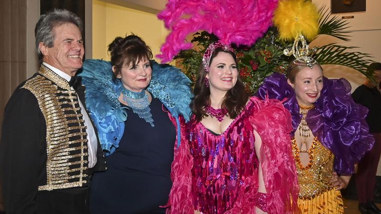 Four people in bright costumes