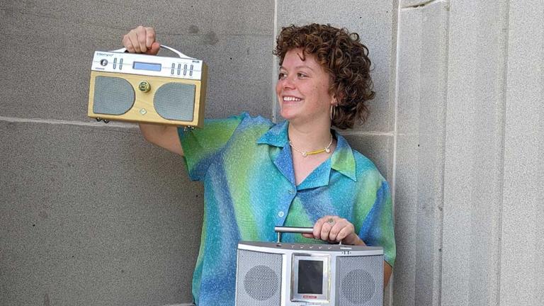 NFSA curator Jo McMahon holding 2 radios