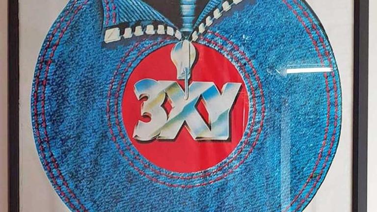A poster for 3XY radio station with a vinyl record on it that's partially covered in denim.