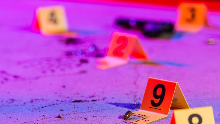 Evidence markers on the ground under neon lighting