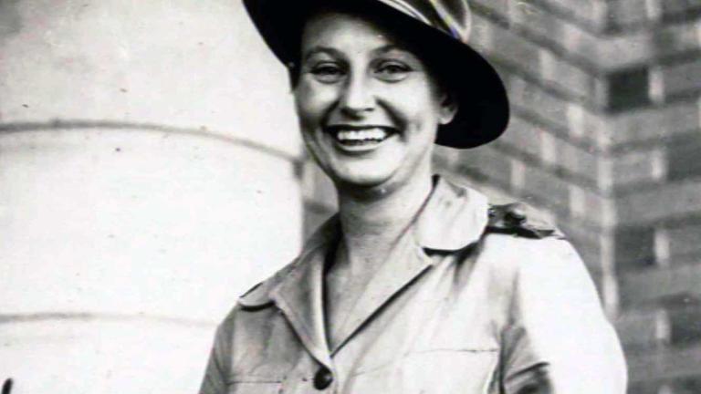 Head and shoulders image of a woman in an army uniform smiling