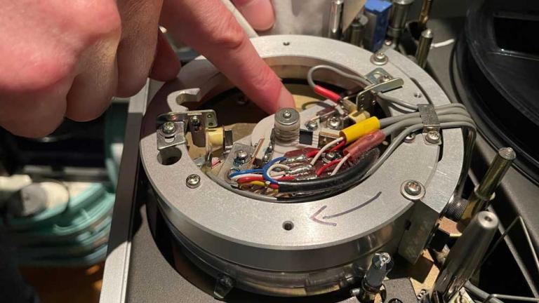 A videotape being cleaned by hand.
