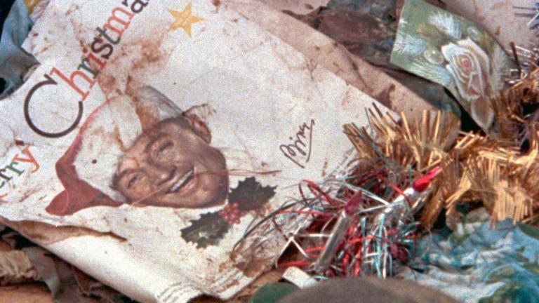 A crumpled record cover of a Christmas album sitting on the ground among wreckage following the devastation of Darwin by Cyclone Tracy in 1974.