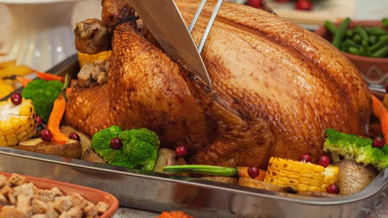 A roast chicken and vegetables on a platter. 