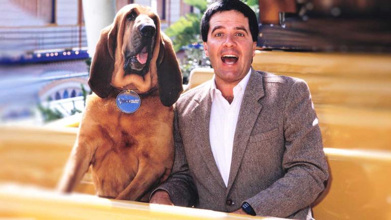 Simon Townsend sitting on a bench with his dog Woodrow