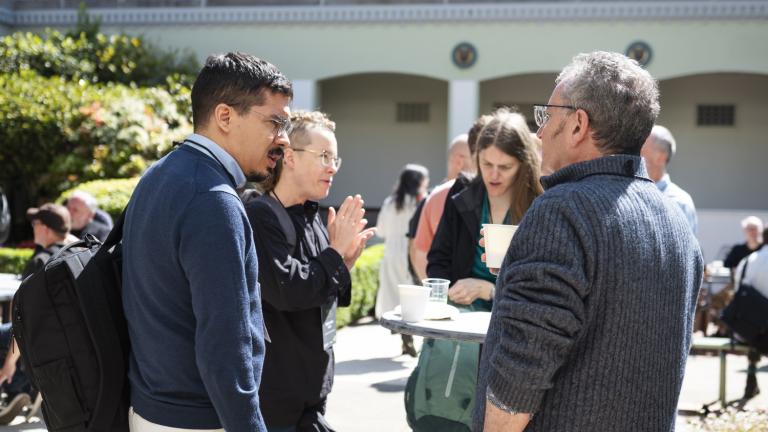 A group chatting in a courtyard