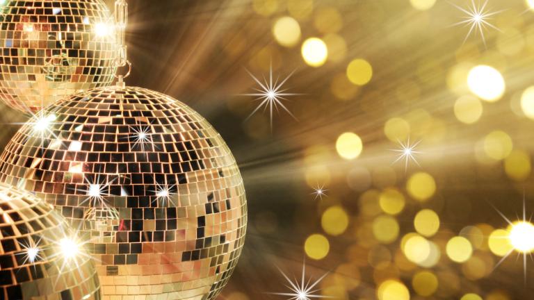 Three glittering disco balls reflecting sparkling golden light
