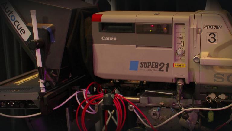 Close up of studio camera equipment, showing a Super 21 camera and autocue machine.
