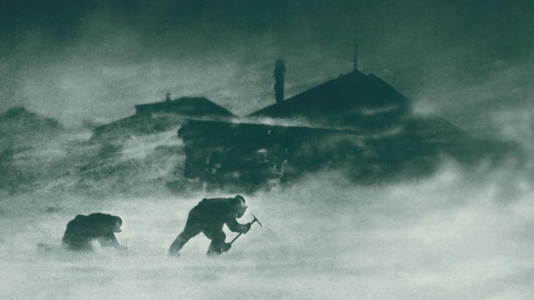 Two men leaning into a blizzard