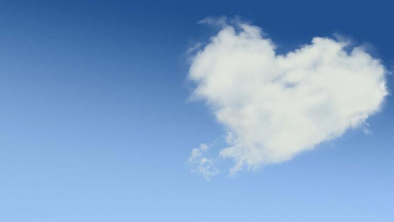 A heart-shaped cloud against a blue sky